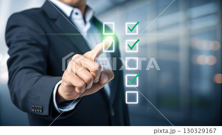 Businessman touching virtual checklist with green checkmark icons conveying productivity and decision making motivation 130329167