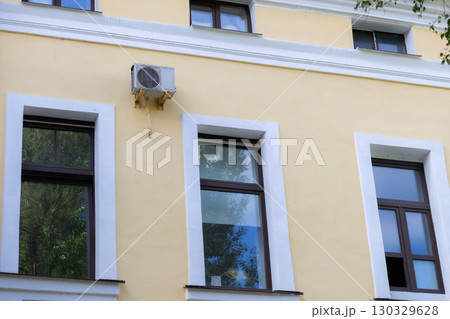 air conditioner is mounted on wall. technologies for air cooling in hot weather. air temperature 130329628