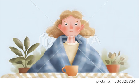 A young Caucasian girl with curly blond hair sits at a table wrapped in a blue blanket. She holds a cup, surrounded by potted plants, evoking a cozy autumn atmosphere. 130329834