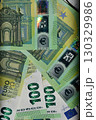 Euro banknote display featuring detailed spectrum design and various denominations stacked together on flat surface 130329986