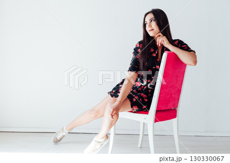 Portrait of a beautiful woman in a black flower dress with a smile 130330067