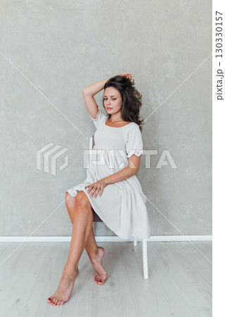Portrait of a beautiful woman in a light summer dress Portrait of a beautiful woman in a light summer dress 130330157