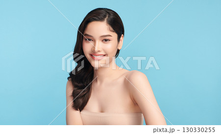 Beautiful Young transgender woman with clean fresh skin on blue background, Face care, Facial treatment, Cosmetology, beauty and spa, transgender women portrait. Beautiful Young transgender woman with clean fresh skin on blue background, Face care, Facial treatment, Cosmetology, beauty and spa, transgender women portrait. 130330255