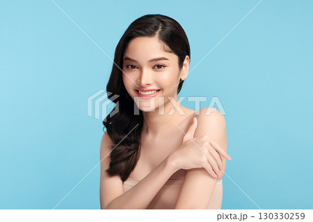 Beautiful Young transgender woman with clean fresh skin on blue background, Face care, Facial treatment, Cosmetology, beauty and spa, transgender women portrait. 130330259