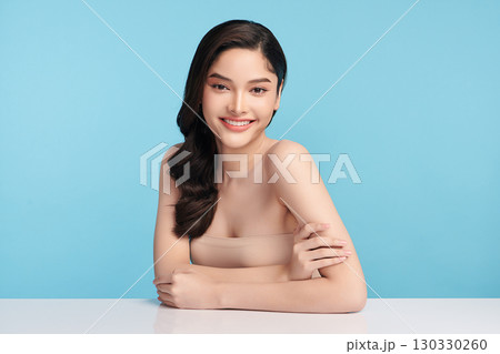 Beautiful Young transgender woman with clean fresh skin on blue background, Face care, Facial treatment, Cosmetology, beauty and spa, transgender women portrait. 130330260