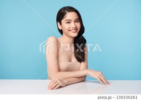 Beautiful Young transgender woman with clean fresh skin on blue background, Face care, Facial treatment, Cosmetology, beauty and spa, transgender women portrait. 130330261