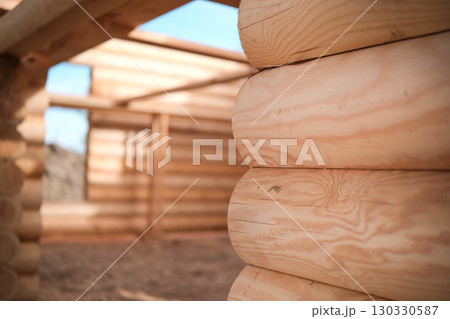 Wooden house building, house made of rounded logs, ecological house Wooden house building, house made of rounded logs, ecological house 130330587
