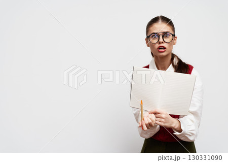 surprised student holding a notebook with a pencil, looking confused, wearing glasses, minimalist background, white color, emphasizing education and curiosity in learning surprised student holding a notebook with a pencil, looking confused, wearing glasses, minimalist background, white color, emphasizing education and curiosity in learning 130331090