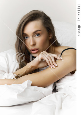 beautiful young woman on white bed linen beautiful young woman on white bed linen 130331131