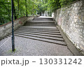 Winding staircase on Petrin Hill in Prague surrounded by lush greenery. Visitors can enjoy a peaceful walk while overlooking the historic charm of the Czech capital. 130331242