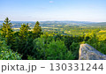 At dusk, the Popov Cliffs in the Lusatian Mountains offer a breathtaking view. Surrounding forested hills and valleys create a tranquil atmosphere perfect for evening exploration. 130331244