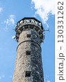 Svatobor lookout tower stands tall with its rugged stone structure and communication equipment. Clear skies enhance the scenic view, inviting visitors to explore the surroundings. 130331262