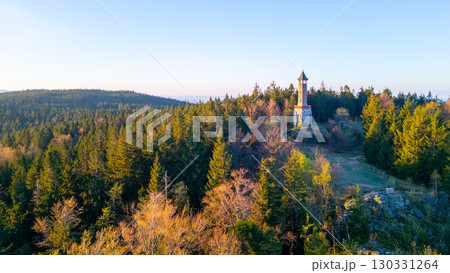 Stepanka Lookout Tower rises majestically in the Jizera Mountains during a serene spring morning. The surrounding forest reveals fresh greenery, inviting nature lovers to explore the area. Stepanka Lookout Tower rises majestically in the Jizera Mountains during a serene spring morning. The surrounding forest reveals fresh greenery, inviting nature lovers to explore the area. 130331264