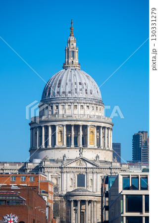 The majestic dome of St. Paul's Cathedral rises against a vibrant blue sky, showcasing its architectural grandeur in the heart of London. It stands as a symbol of historical significance. The majestic dome of St. Paul's Cathedral rises against a vibrant blue sky, showcasing its architectural grandeur in the heart of London. It stands as a symbol of historical significance. 130331279