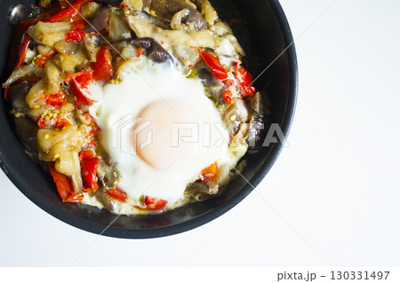 Cooked vegetables with poached egg 130331497