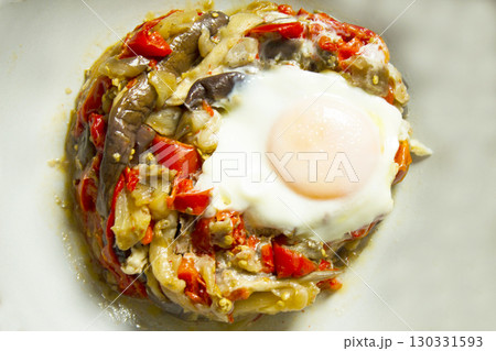 Cooked vegetables with poached egg 130331593