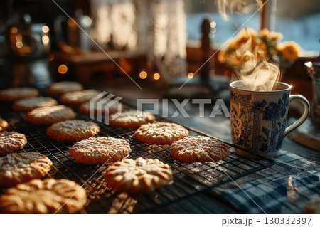 Warm cookies cooling on rack with steaming cup of tea in cozy kitchen setting 130332397