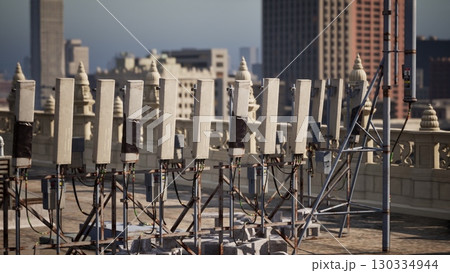 Row of Electrical Wires on Rooftop Conveys Urban Landscape in Metropolis Row of Electrical Wires on Rooftop Conveys Urban Landscape in Metropolis 130334944