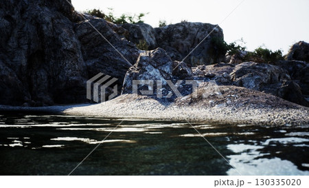 A breathtaking rock formation rises from the tranquil waters, creating a stunning sight on the Spanish coast. A breathtaking rock formation rises from the tranquil waters, creating a stunning sight on the Spanish coast. 130335020