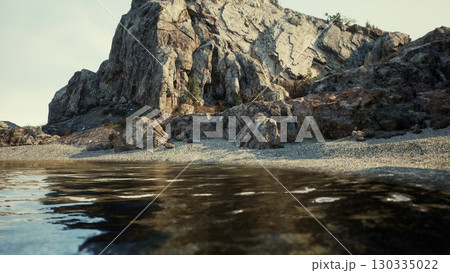A breathtaking rocky mountain in Spain, overlooking a serene body of water. A breathtaking rocky mountain in Spain, overlooking a serene body of water. 130335022