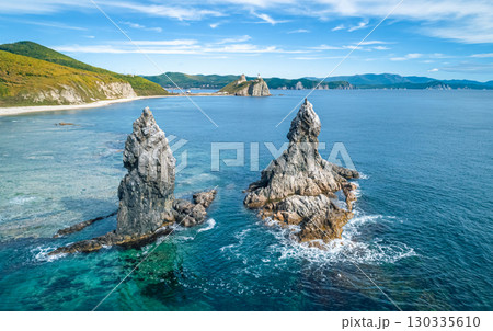 Stunning coastal landscape at sunrise with distinct rock formations and clear ocean waters 130335610