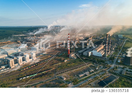 Industrial pollution causes environmental degradation in a large manufacturing facility with smoke and emissions during daytime Industrial pollution causes environmental degradation in a large manufacturing facility with smoke and emissions during daytime 130335718