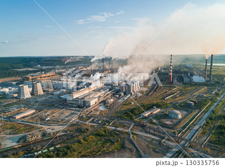 Air pollution from industrial facilities causes environmental concerns in urban areas during sunset hours. Air pollution from industrial facilities causes environmental concerns in urban areas during sunset hours. 130335756