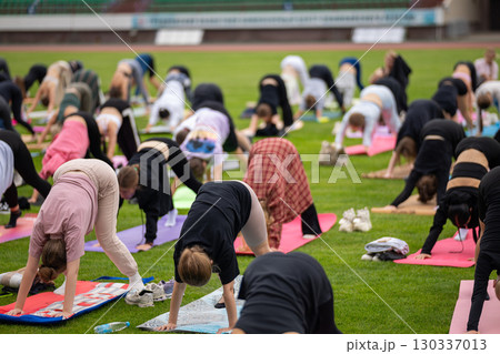 Group yoga session on stadium lawn in FYSM style 130337013