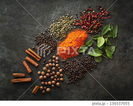 Various Indian spices set against a dark and rustic background. 130337055