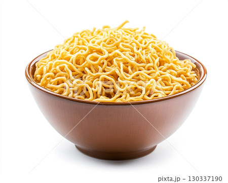 A bowl holds a pile of golden instant noodles, showcasing their curly, wavy texture against a clean white background. 130337190
