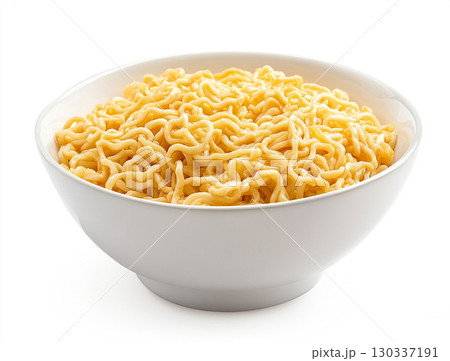 A bowl holds a pile of golden instant noodles, showcasing their curly, wavy texture against a clean white background. 130337191