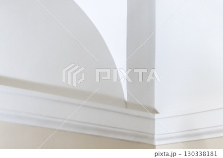 Elegant minimal interior design showcasing a tranquil white wall Elegant minimal interior design showcasing a tranquil white wall 130338181