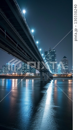 Modern city bridge with skyline reflections at night 130338240