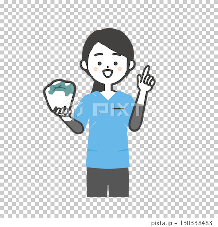 一位穿著手術服的女士舉起手指，握著一顆補好的臼齒 130338483