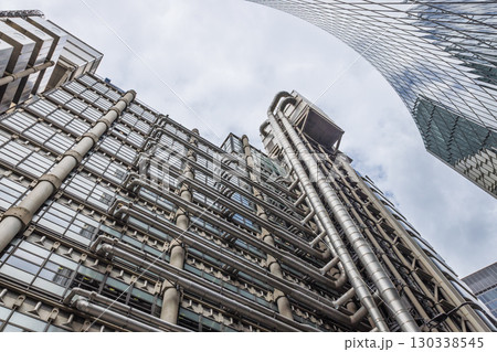 Futuristic high tech office tower with exposed pipes and lifts 130338545