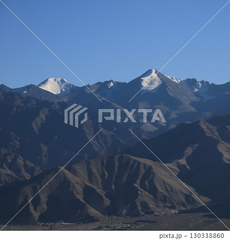 Glaciers on high peaks of the Zanskar Range, view from Leh, India. 130338860