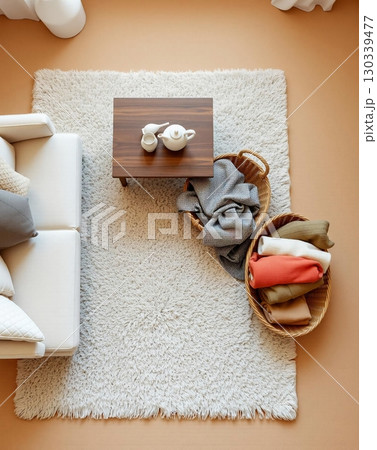 Cozy Living Room Arrangement with Soft Textures and Warm Tones 130339477