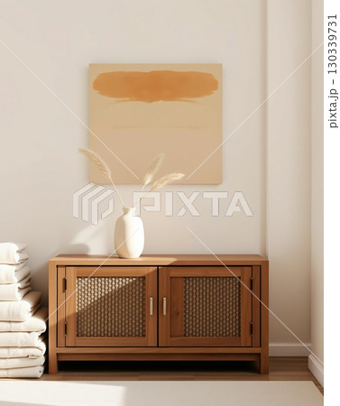 Elegant interior with modern artwork, a wooden cabinet, and a decorative vase with plants. 130339731