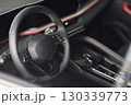 Closeup of a modern car steering wheel with control buttons for technology and convenience 130339773
