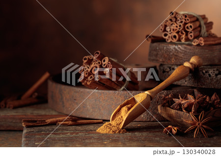 Cinnamon and anise on a brown vintage background. Cinnamon and anise on a brown vintage background. 130340028