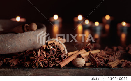 Cinnamon sticks, anise, and nutmeg on a old wooden table. Cinnamon sticks, anise, and nutmeg on a old wooden table. 130340031