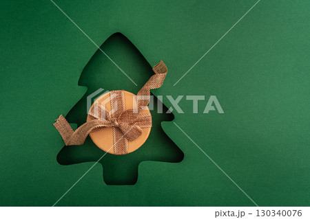 Christmas Gift Box with Red Ribbon in Tree Cutout Design Christmas Gift Box with Red Ribbon in Tree Cutout Design 130340076