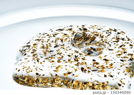 Mouth-watering thick texture of 24k gold serum. Mouth-watering thick texture of 24k gold serum. 130340090