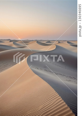 Gently undulating sand dunes in a vast desert landscape, illuminated by soft pastel hues of a setting or rising sun 130340895