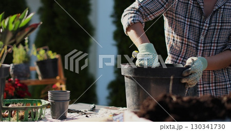 Preparation for transplanting a houseplant using extended clay, soil, shovel, rake and flowerpot. Home gardening. Hobbies and leisure concept. Preparation for transplanting a houseplant using extended clay, soil, shovel, rake and flowerpot. Home gardening. Hobbies and leisure concept. 130341730