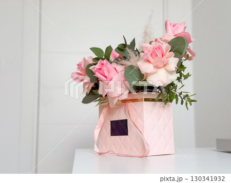 Bouquet of pink roses with greenery. Elegance, romance, and floral expression of love and beauty in decorative arrangement. Bouquet of pink roses with greenery. Elegance, romance, and floral expression of love and beauty in decorative arrangement. 130341932