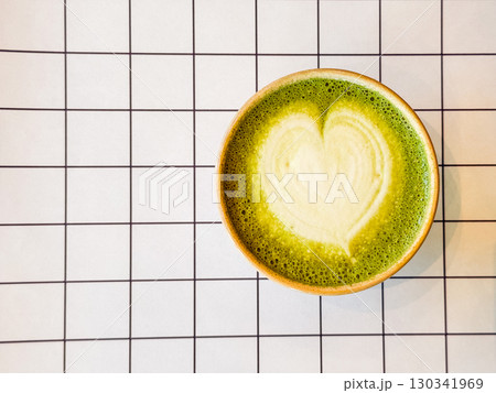 Top view of matcha latte with heart design. Copy space. Nutrition, relaxation, and beverage culture in modern minimalist cafe. Top view of matcha latte with heart design. Copy space. Nutrition, relaxation, and beverage culture in modern minimalist cafe. 130341969