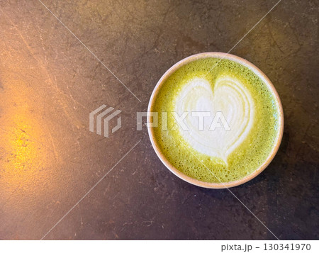 Cup of matcha latte with heart foam. Copy space. Wellness, relaxation, and lifestyle beverage culture in cafe setting. 130341970