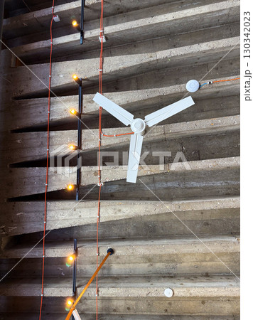 Ceiling fan with industrial lights. Modern architecture, utility, and minimalist design in interior environment. Ceiling fan with industrial lights. Modern architecture, utility, and minimalist design in interior environment. 130342023