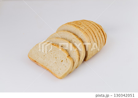 Sliced white bread loaf with sesame on white background, ideal for bakery or food packaging Sliced white bread loaf with sesame on white background, ideal for bakery or food packaging 130342051